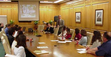 Photo of people in a meeting room at a large table